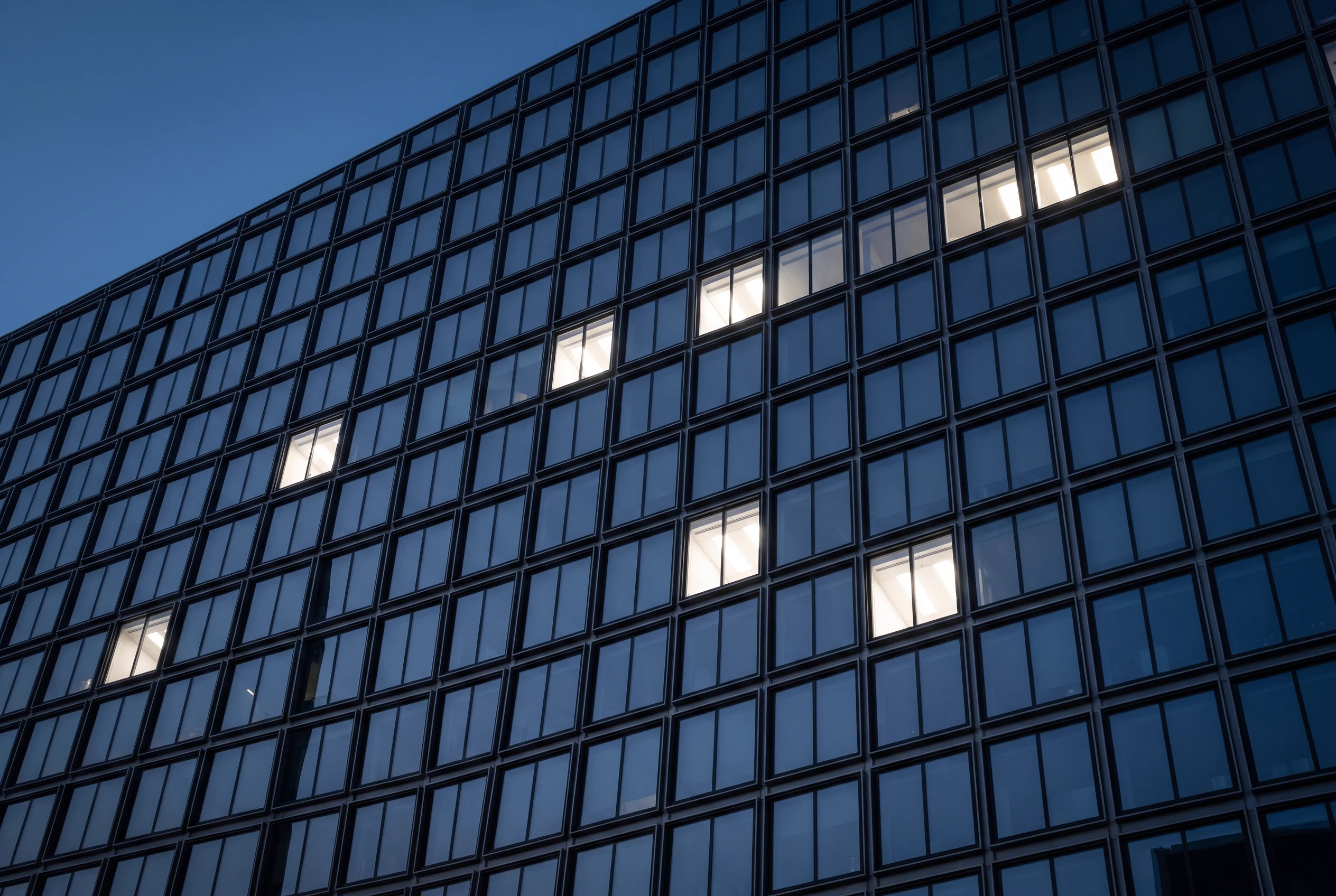 Glass office façade in London at blue hour